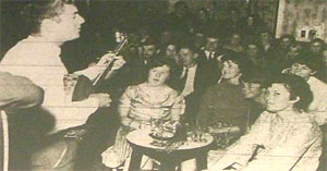 Caption: Folk music fans listen attentively as one of Britain's top folk teams, the Ian Campbell Group, play in Tamworth.