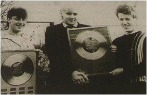 Caption: The prize is right… Dream Factory members Lloyd Bennett (left) and Mark Mortimer hold the Herald’s exclusive Best Band and Best local Song gold discs which they won last year. But who will be holding them in ’86?