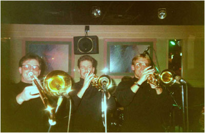Bash Out The Odd's brass section pictured live on stage in December, 1989 in Nuneaton at a club called Graysons. Left to right: Bryan Hudley (bass trombone), Martin Cooper (trumpet & Eb trumpet), Mark Allison (trumpet, cornet).